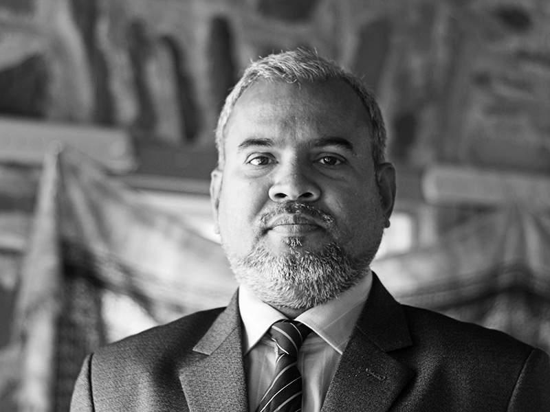 Black and white portrait of Dr. Abul Kashem Mohammad Jamal Uddin - wearing a nice suit and striped tie. He has short hair and a well trimmed short beard