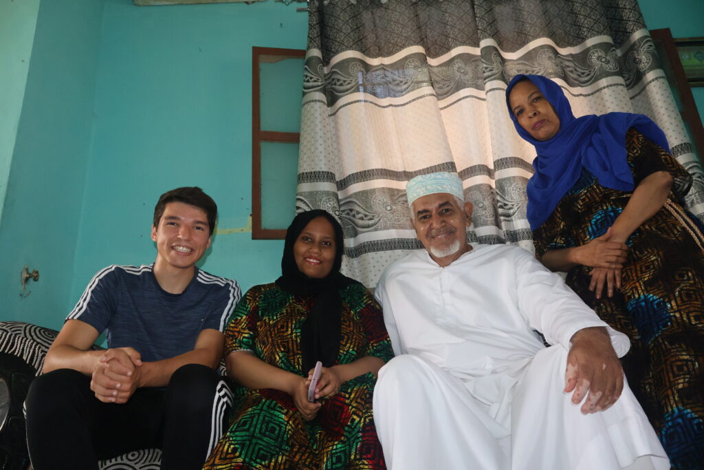 SIT Study Abroad student Christian Boudreaux with host family in Tanzania